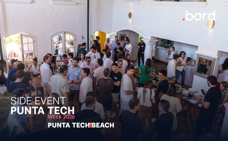 Attendees mingle by food tables in a white hall; text: Side Event Punta Tech Week 2026