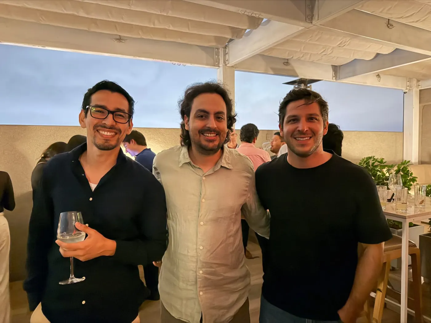 Three attendees smile on the terrace at Across LATAM After Office in Lima