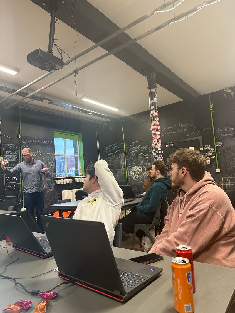 Martin Naughton speaking with the Christmas hackathon team at Farset Labs, Belfast.