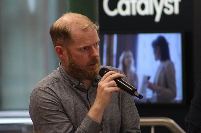 Martin Naughton speaking into a microphone during the Catalyst discussion.