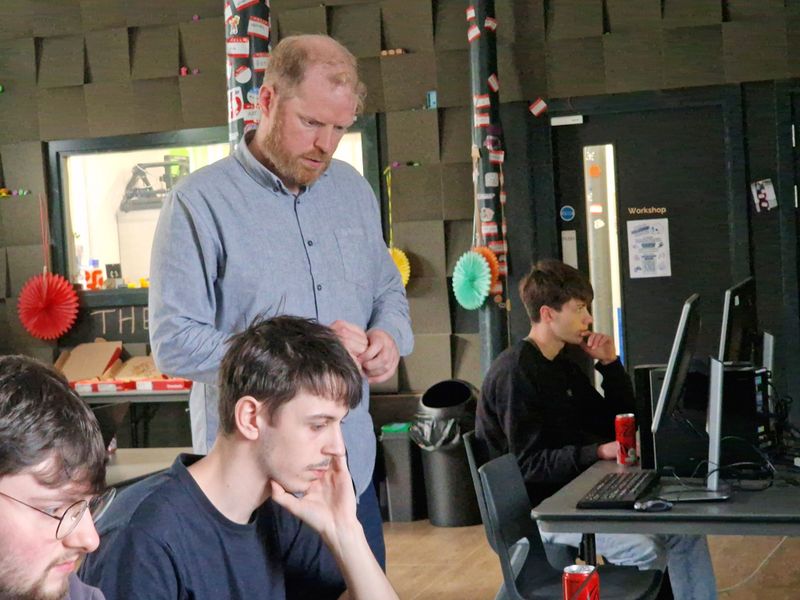 Martin Naughton working alongside students at Pizza and Programming.
