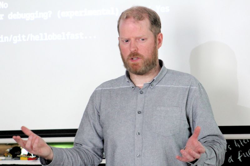 Martin Naughton explaining programming concepts to students at Farset Labs.