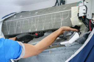 A professional technician repairing an AC unit