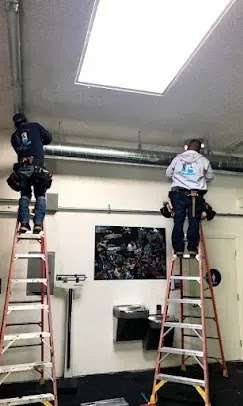 Technician cleaning ducts in a home, highlighting the importance of regular duct cleaning for indoor air quality
