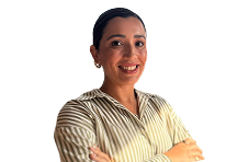 Smiling woman with dark hair tied back, wearing a striped beige shirt with arms crossed.