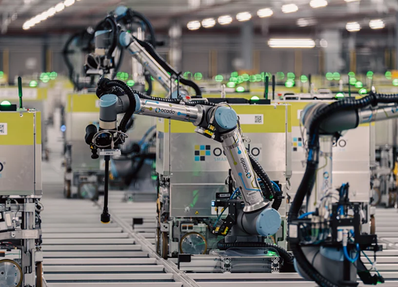 a group of robotic arms in a factory