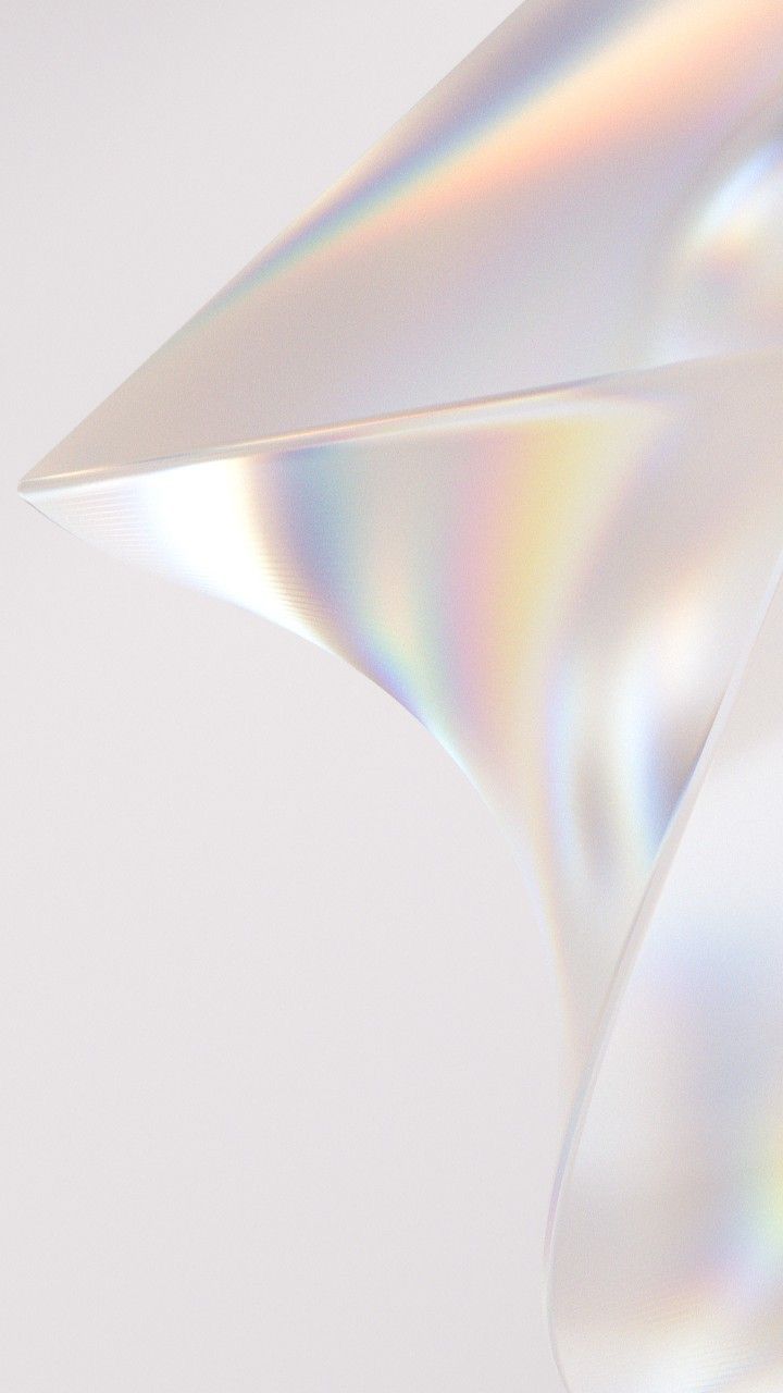 Close-up of a translucent, iridescent, folded material with soft rainbow reflections on a light background.