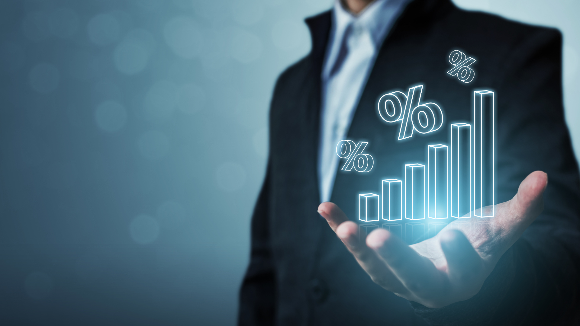 person holding a bar graph with percentage sign on top of it depicting interest rate