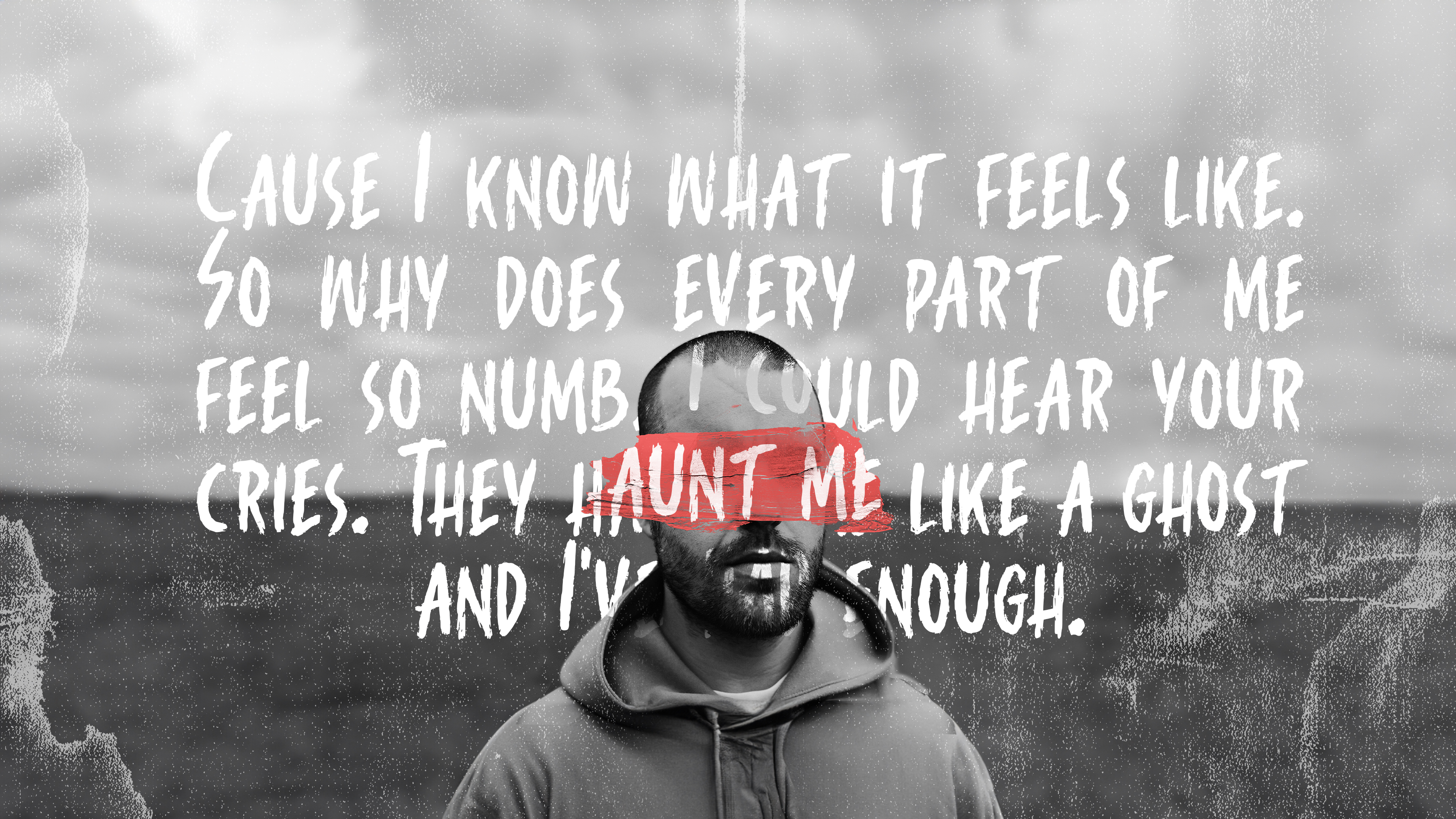 Black and white photo of a man in a hoodie with a red brushstroke over his eyes and a handwritten-style quote about feeling numb and haunted.
