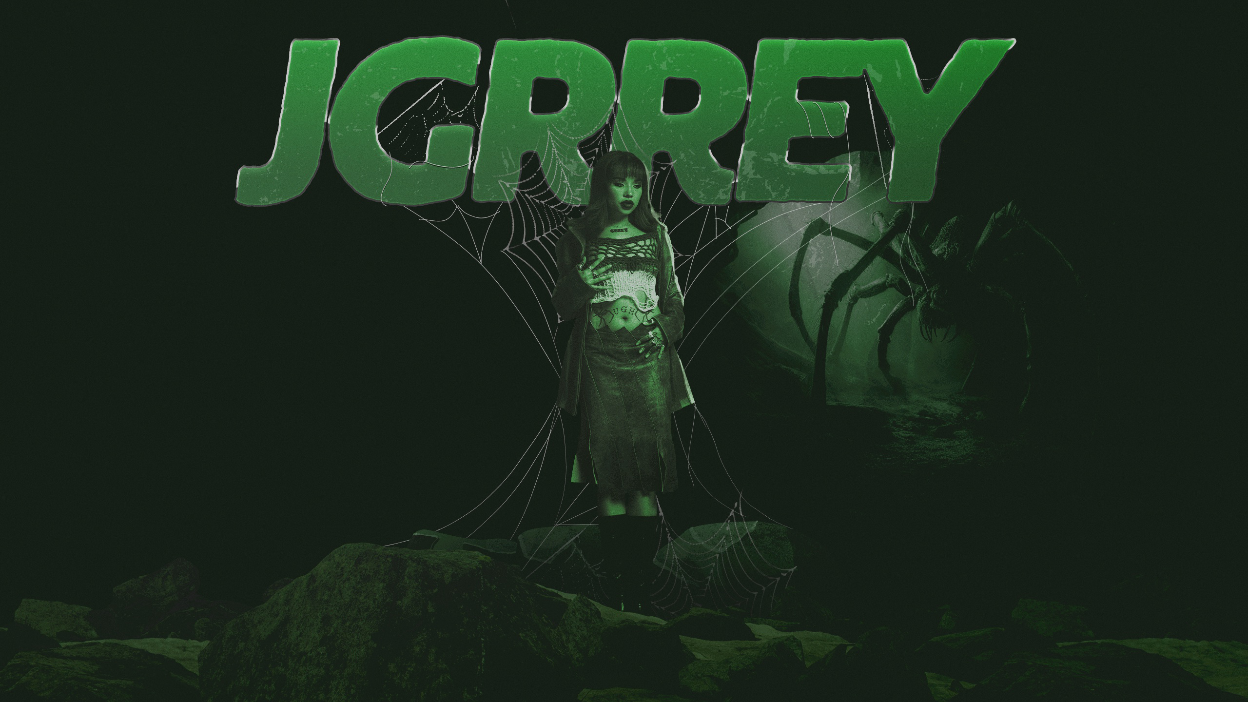 Woman standing on rocks in front of a large green spider and a web with the word JCPRREY above her.
