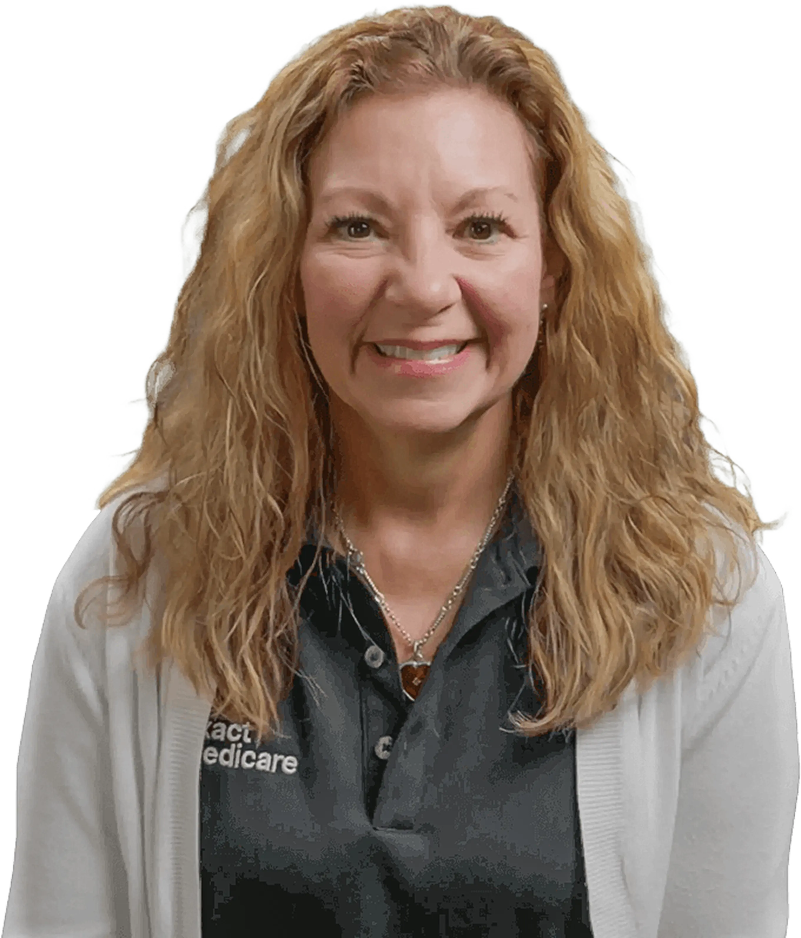 Smiling woman with wavy blonde hair wearing a black shirt and white cardigan.