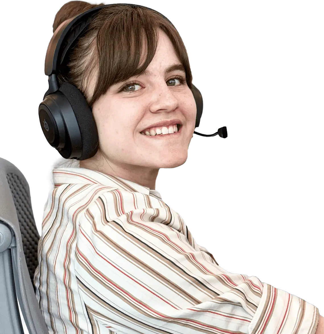 Smiling woman with brown hair wearing a striped shirt and black headset with microphone, seated in an office chair.