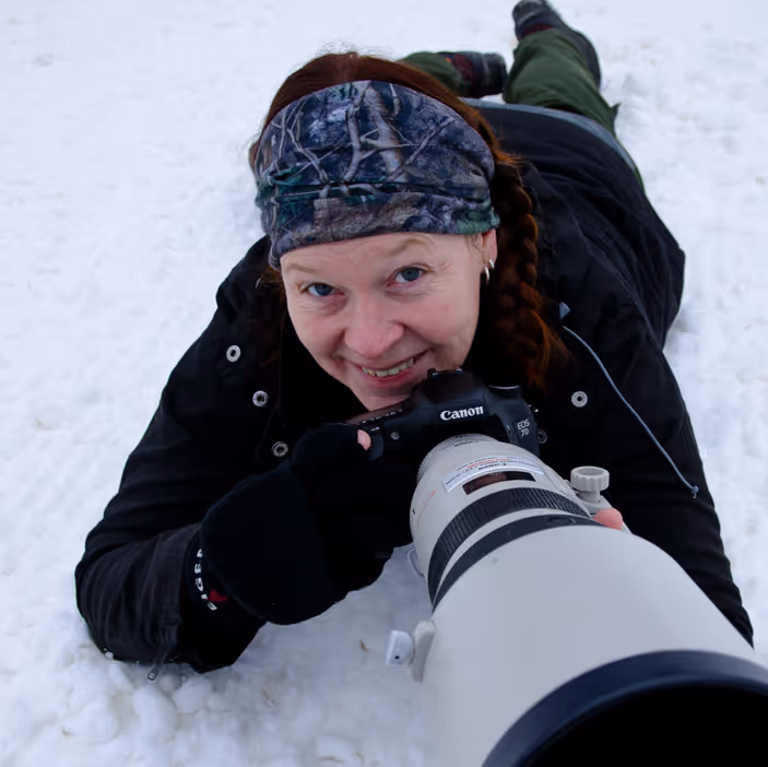 Image of Sara with a camera in the snow