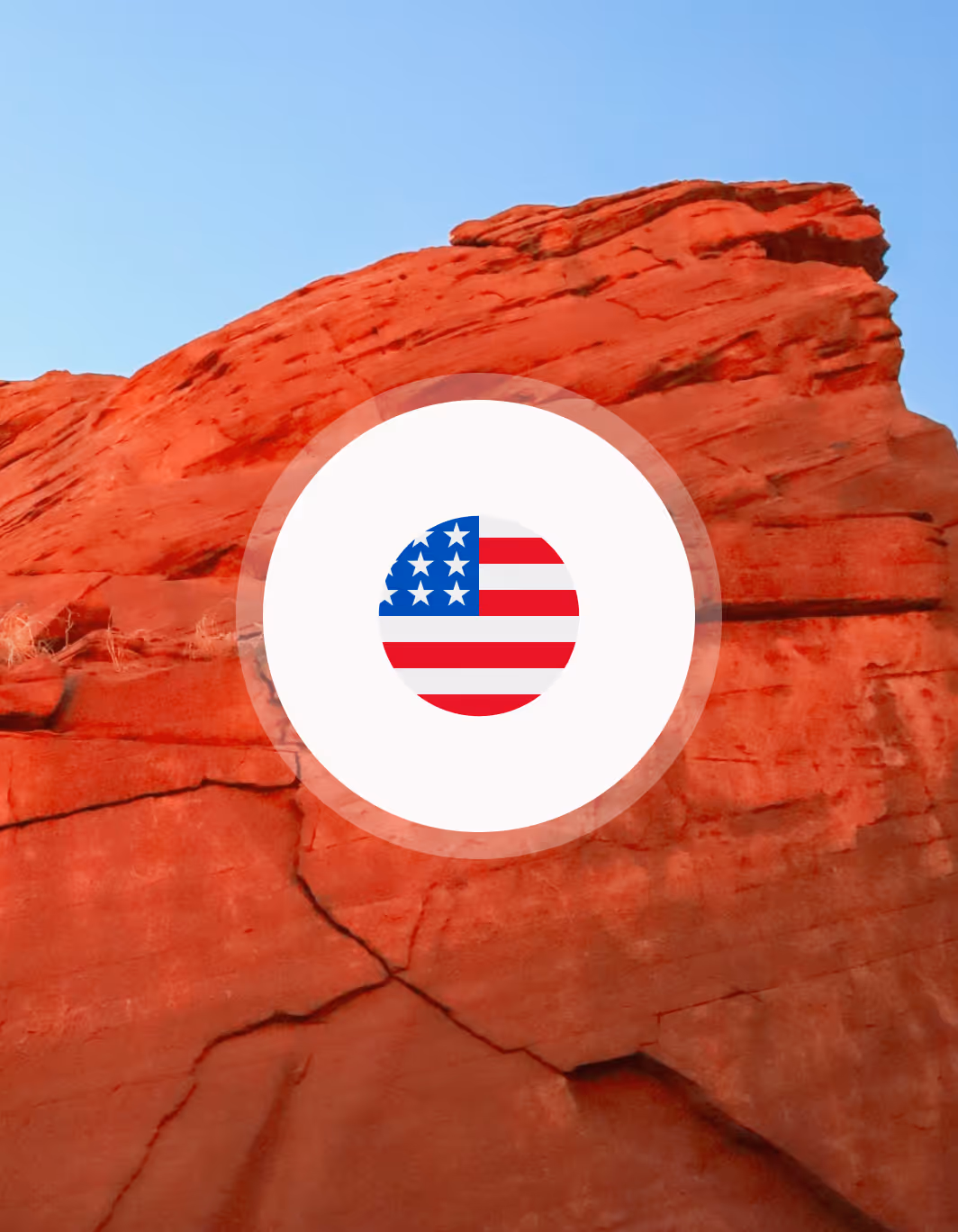 Red rock formation under a clear blue sky with a circular United States flag graphic overlay.