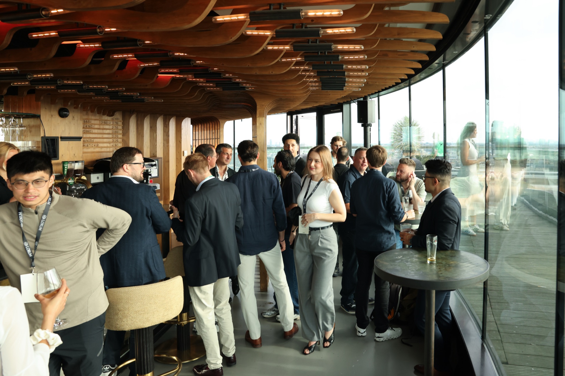 The Lorum team talking with guests at a rooftop event