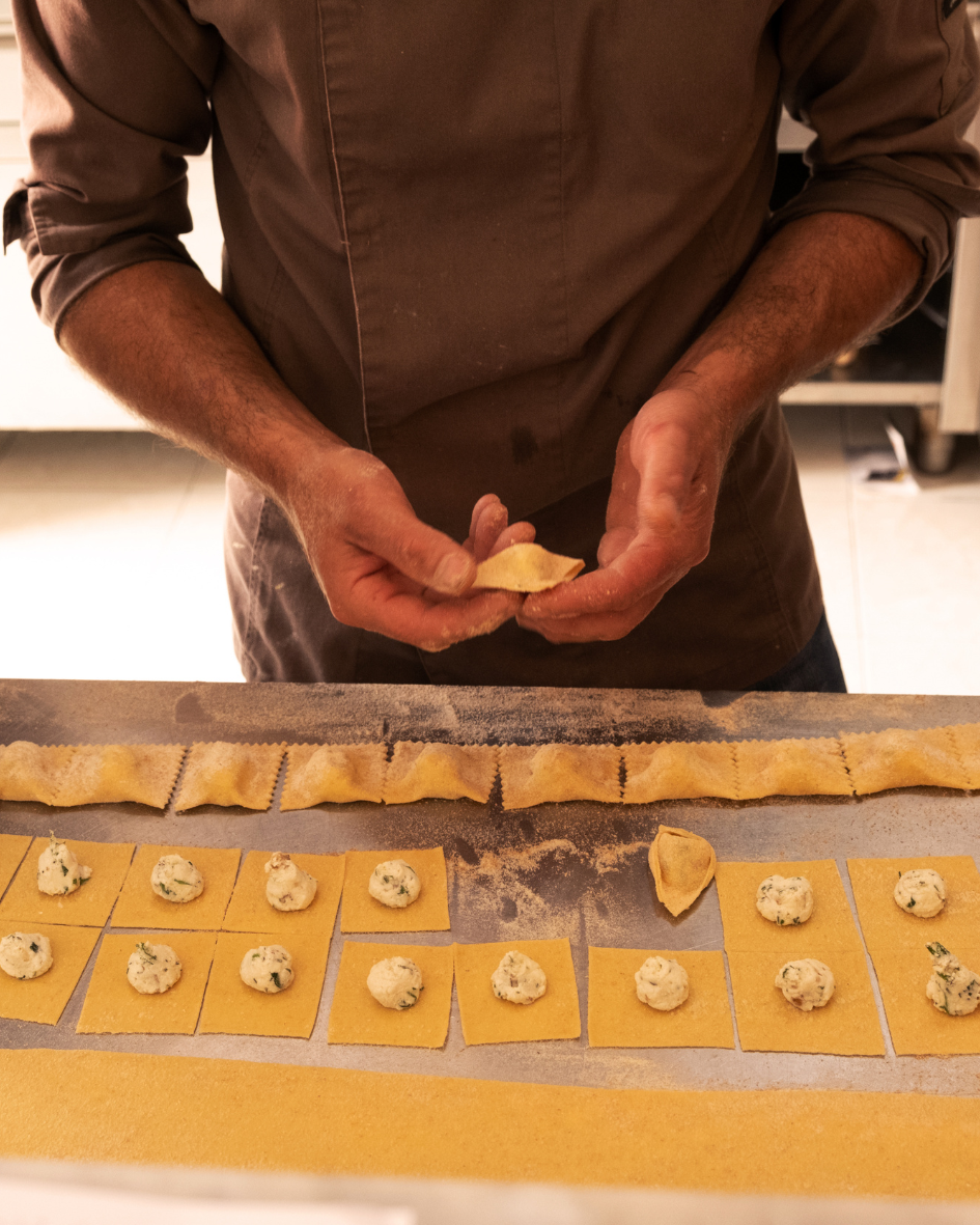 Chef Francesco making homemade vegetarian pasta at Floripa Surf and Yoga Retreat in Sicily, showcasing authentic Italian slow food and in-house cuisine