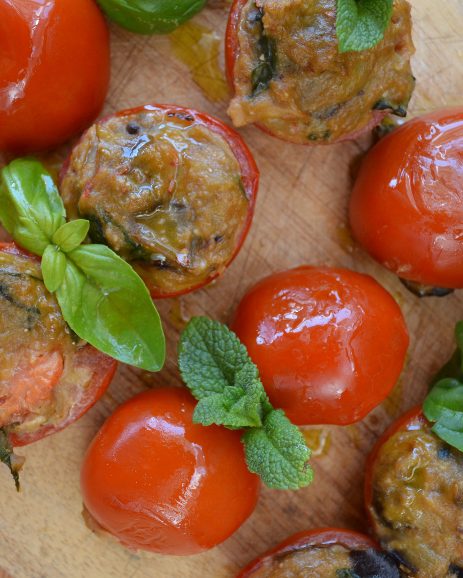 Stuffed tomatoes with herbs and vegetables from the vegetarian Italian menu at Floripa Surf and Yoga Retreat in Sicily, garnished with fresh basil and mint