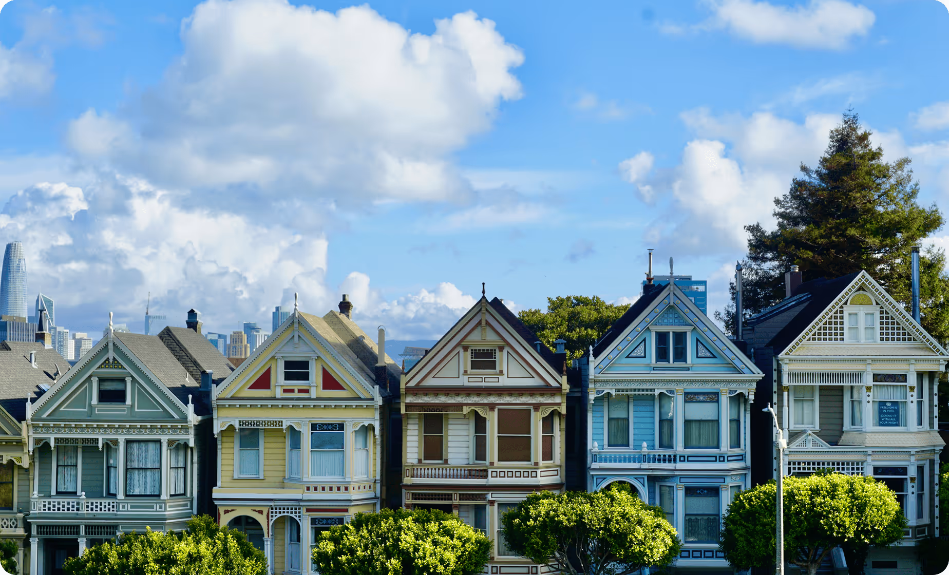 a row of houses with trees in front of them