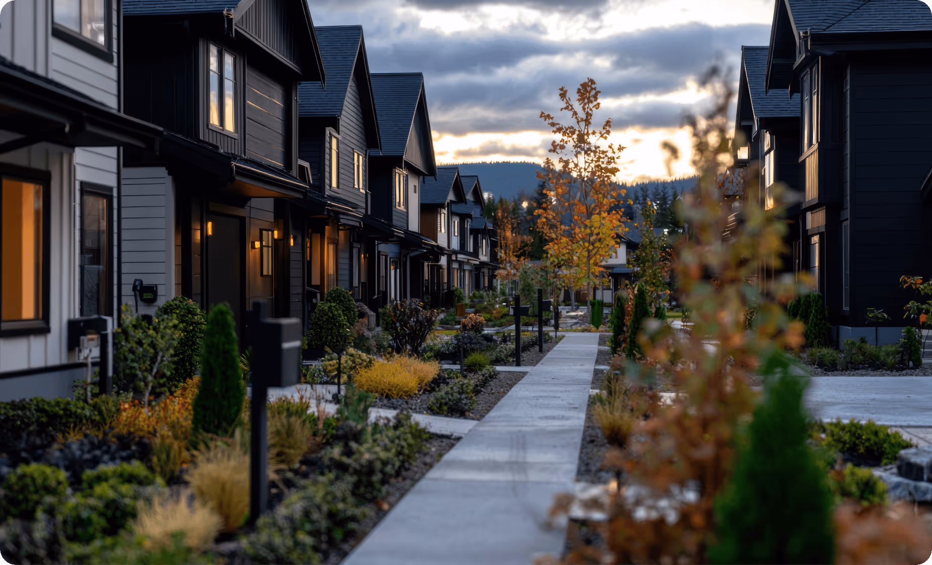 a row of houses with trees and bushes