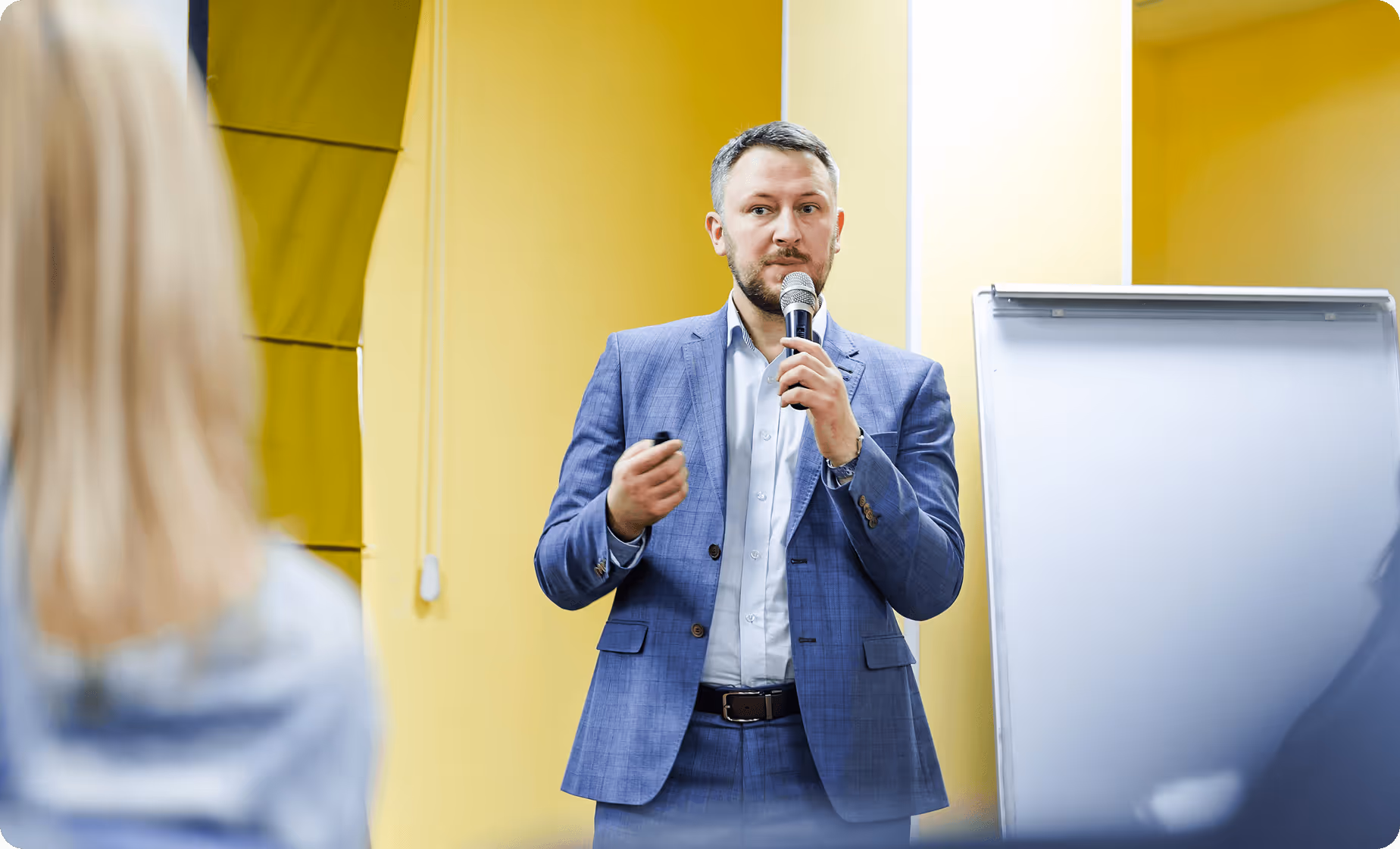 a man in a suit holding a microphone