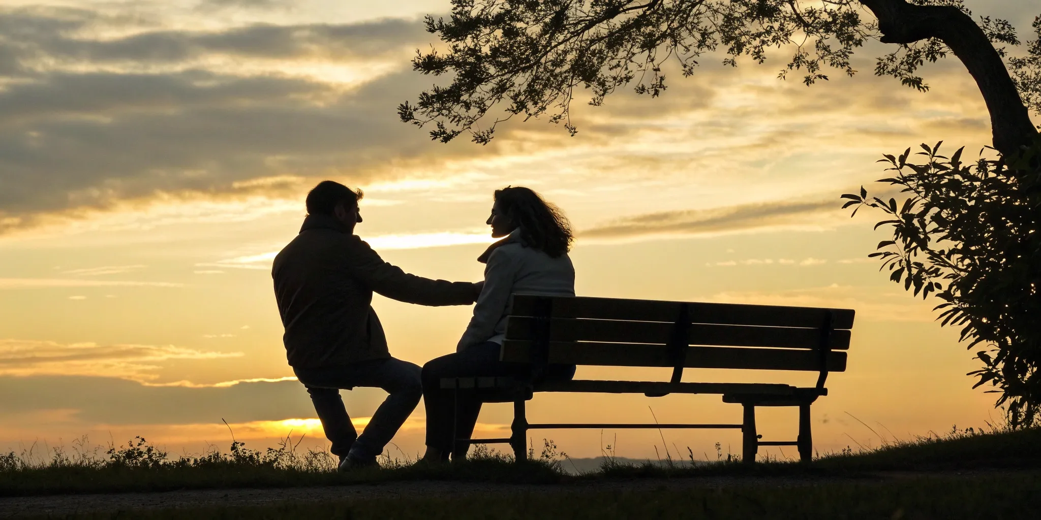 A couple on a bench at sunset, facing the question of how long relationship anxiety lasts.