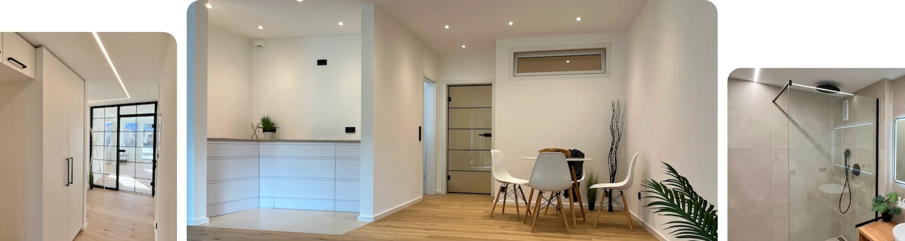 Moderner Flur mit hellen Wänden, einem Sitzbereich mit weißem Tisch und Stühlen und holzfarbenem Boden.