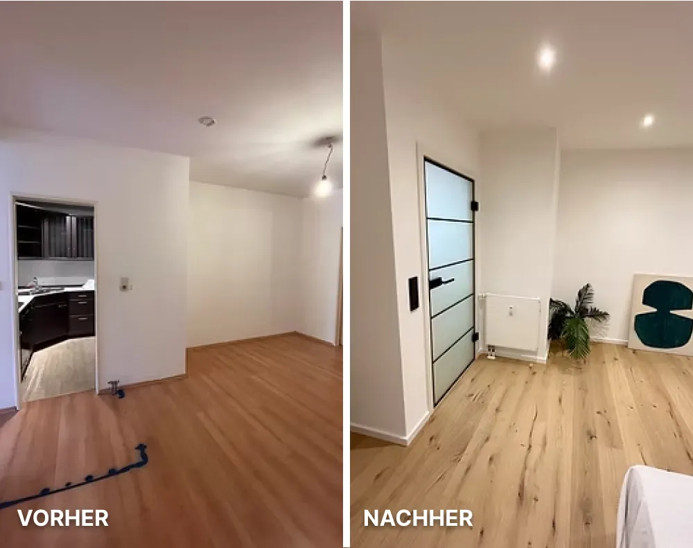Moderne helle Küche mit weißen Schränken, Holzarbeitsplatte, Kochfeld und großer Fensterfront mit Blick auf Nachbarhäuser.