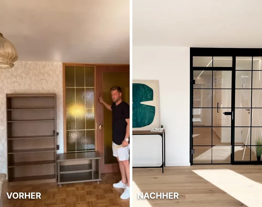 Moderne helle Küche mit weißen Schränken, Holzarbeitsplatte, Kochfeld und großer Fensterfront mit Blick auf Nachbarhäuser.