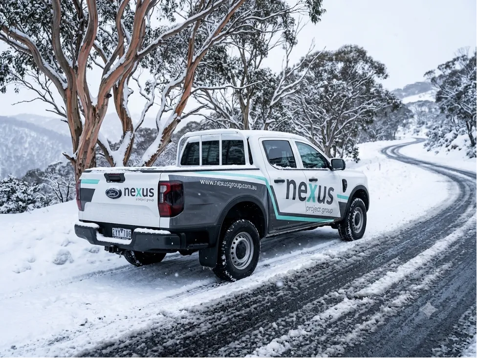 Nexus ute driving along a snowy alpine road