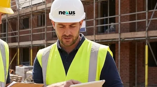 Site supervisor in a hard hat and high-vis vest on a construction site