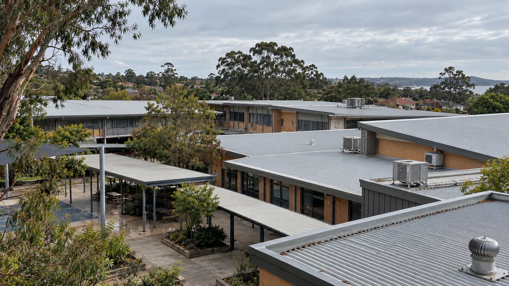 Aerial view of school buildings with metal roofs