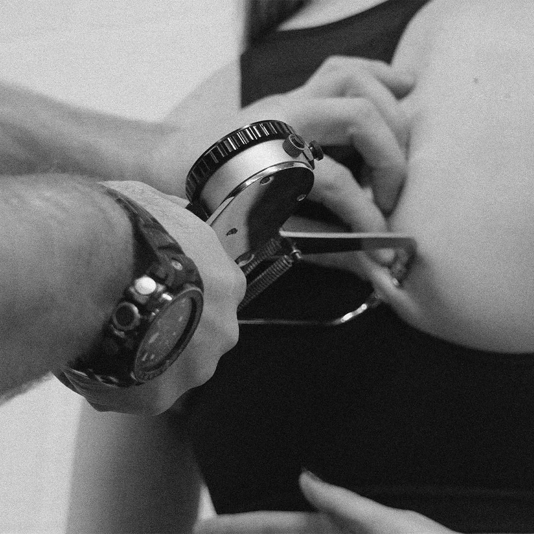 Person using a caliper to measure body fat on an arm.