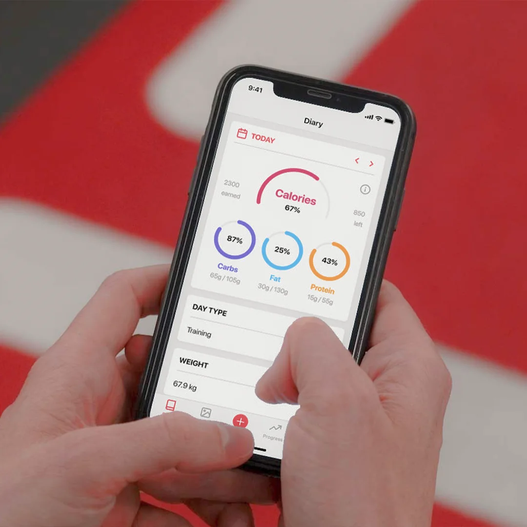 Smartphone screen showing a nutrition tracking app displaying calories burned and intake percentages for carbs, fat, and protein.