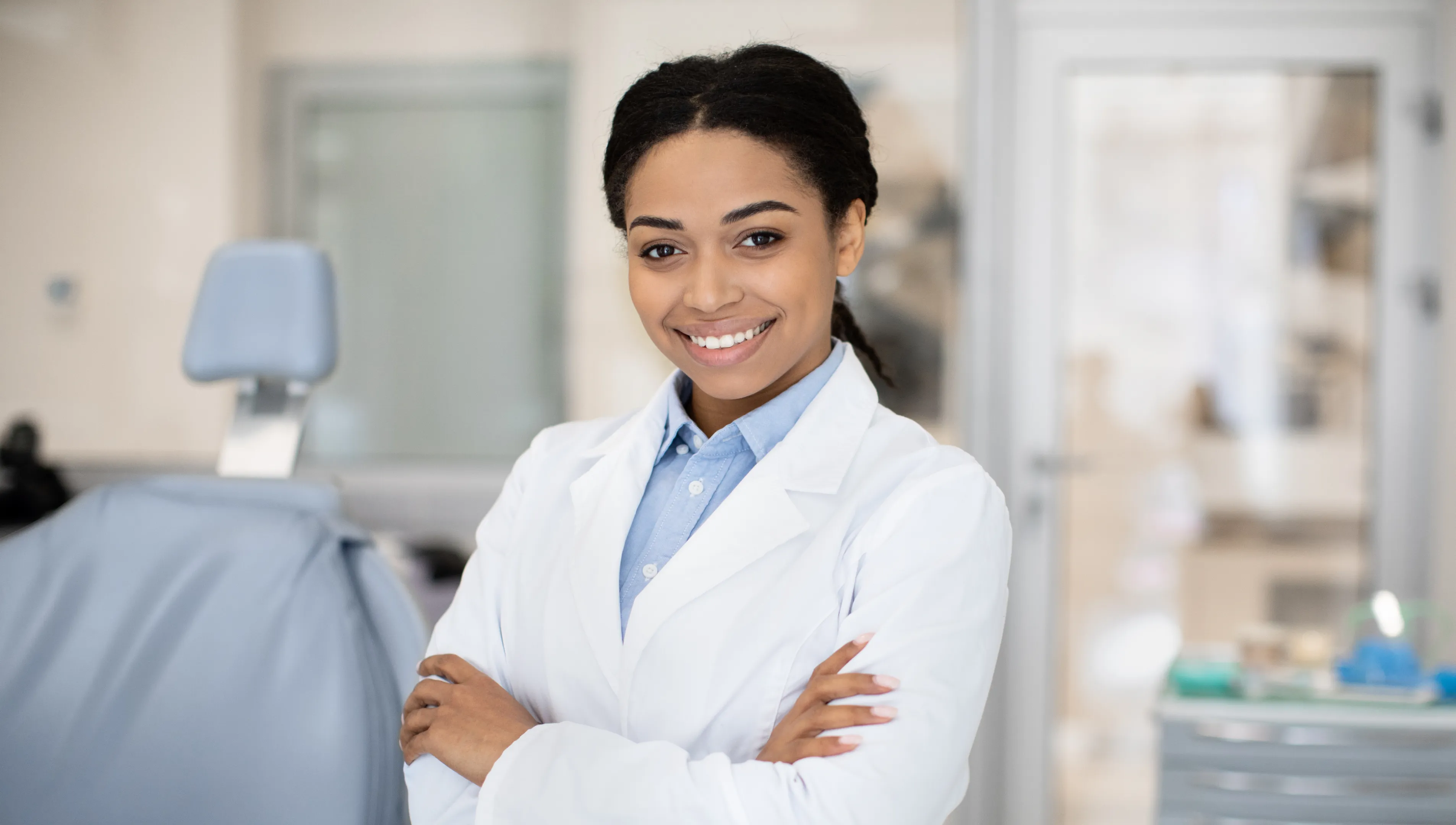 A woman in a lab coat standing in a room.