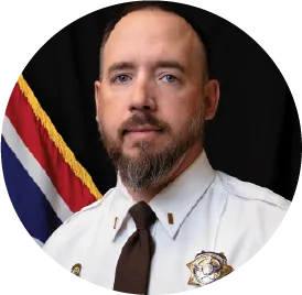 Military or law enforcement official in uniform with national flag background