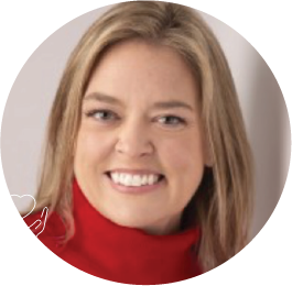 Smiling person in red turtleneck against neutral background