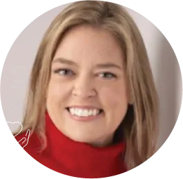 Smiling person in red turtleneck against neutral background