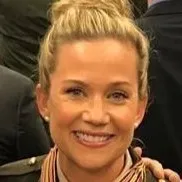 Smiling woman with blonde hair pulled back wearing a striped scarf