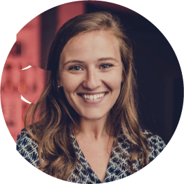Smiling woman with wavy hair in professional headshot portrait