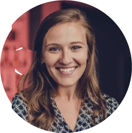 Smiling woman with wavy hair in professional headshot portrait