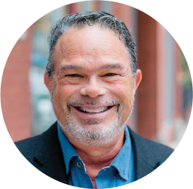 Smiling middle-aged professional wearing blue shirt and dark jacket