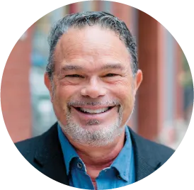 Smiling middle-aged professional wearing blue shirt and dark jacket