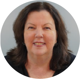 Smiling professional woman with shoulder-length dark hair against gray background