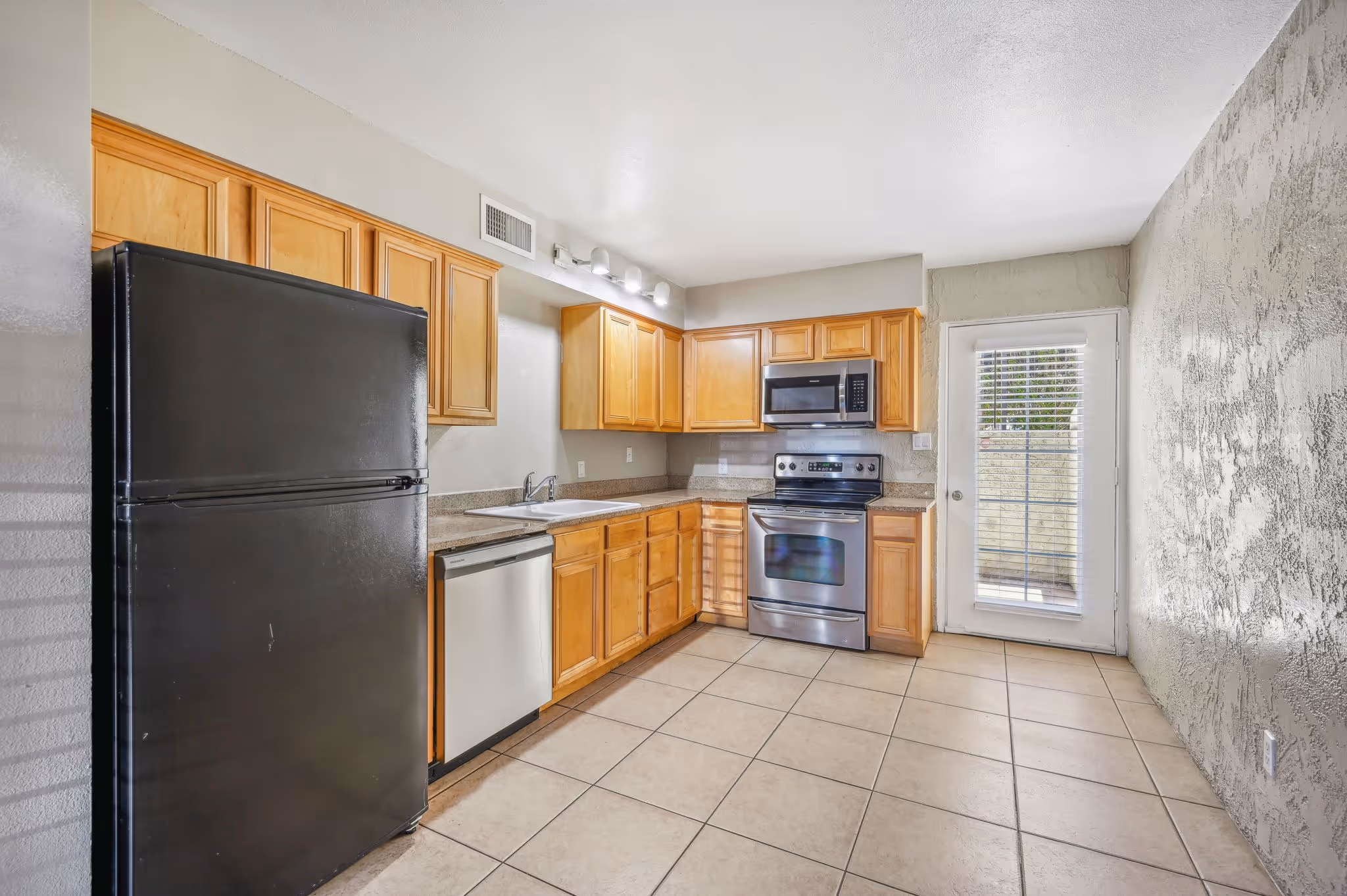 Kitchen with cabinets and black and stainless steel appliances