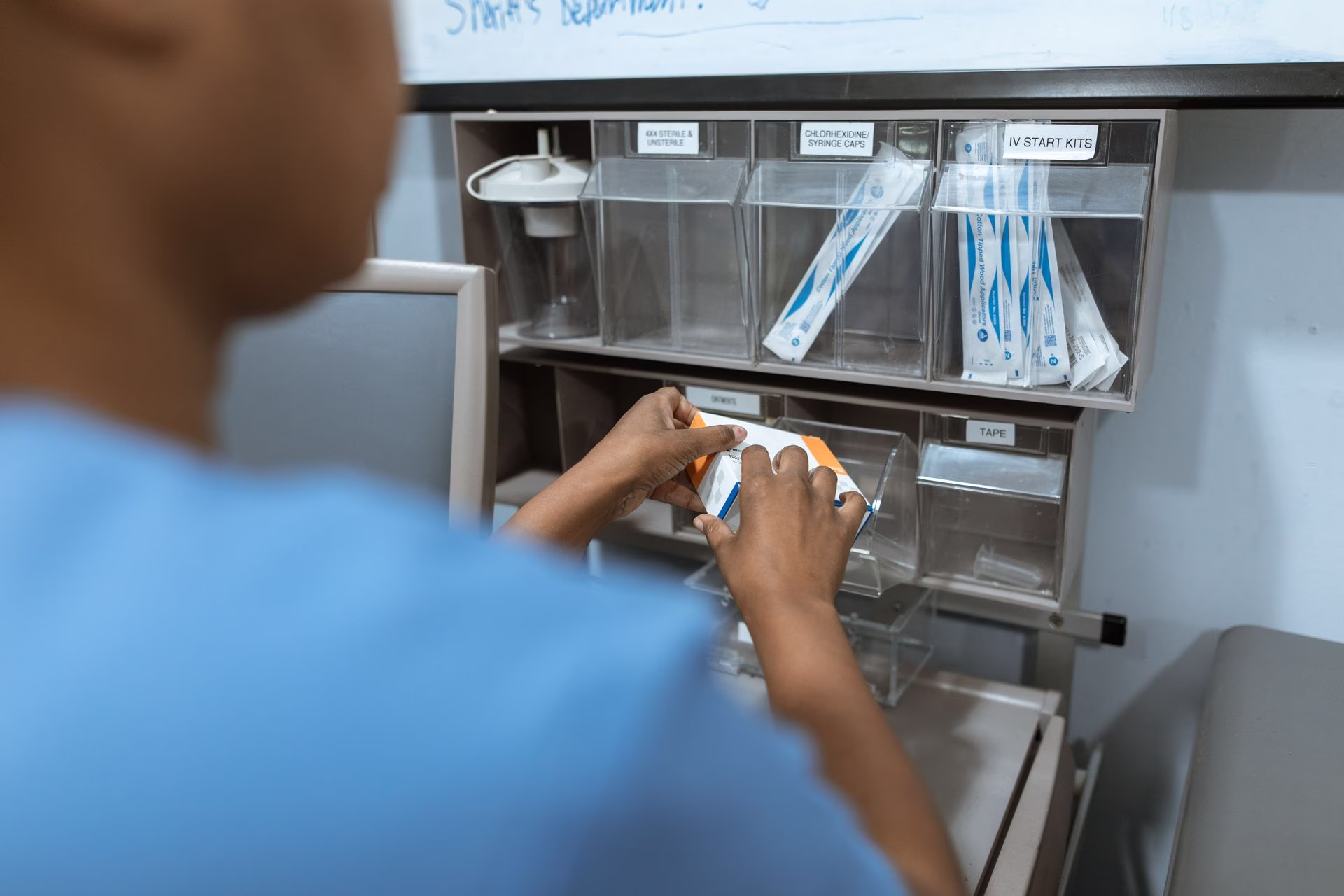 Nurse scanning a medication barcode at a mobile cart before administration.