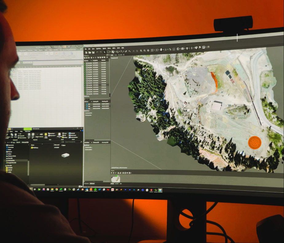 An image of a man looking at a 3d model of a survey, in a warm orange room