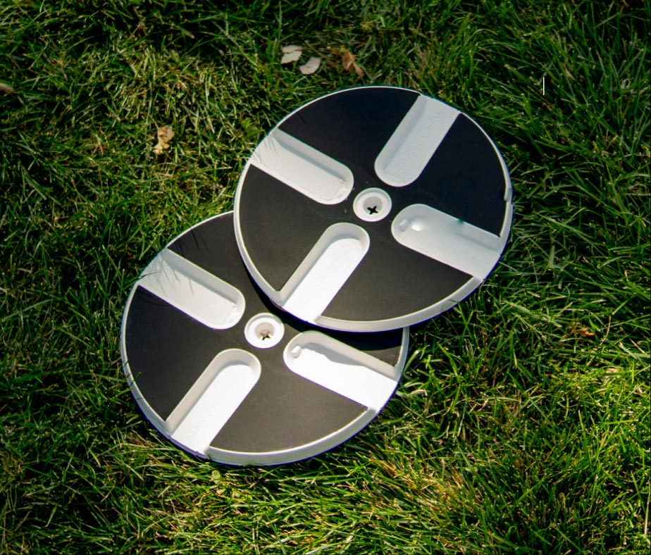 An image of 2 DronePoint targets on grass