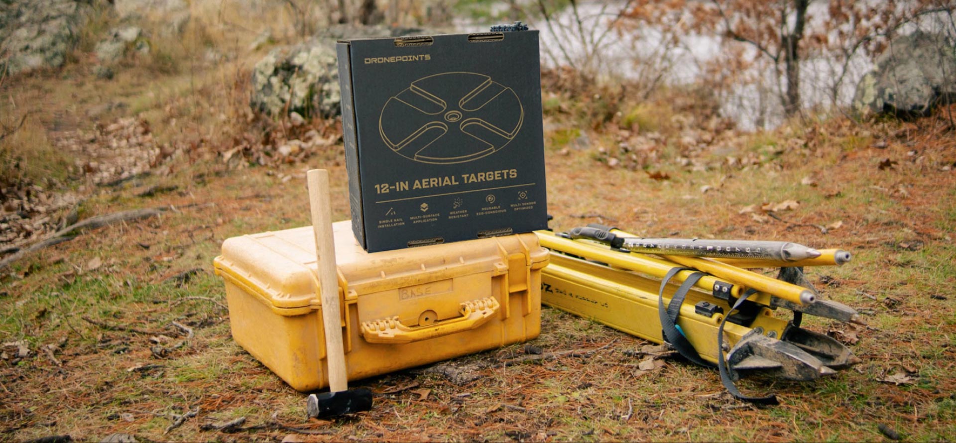 A photo of the updated DronePoints box design on top of surveying tools in the wilderness