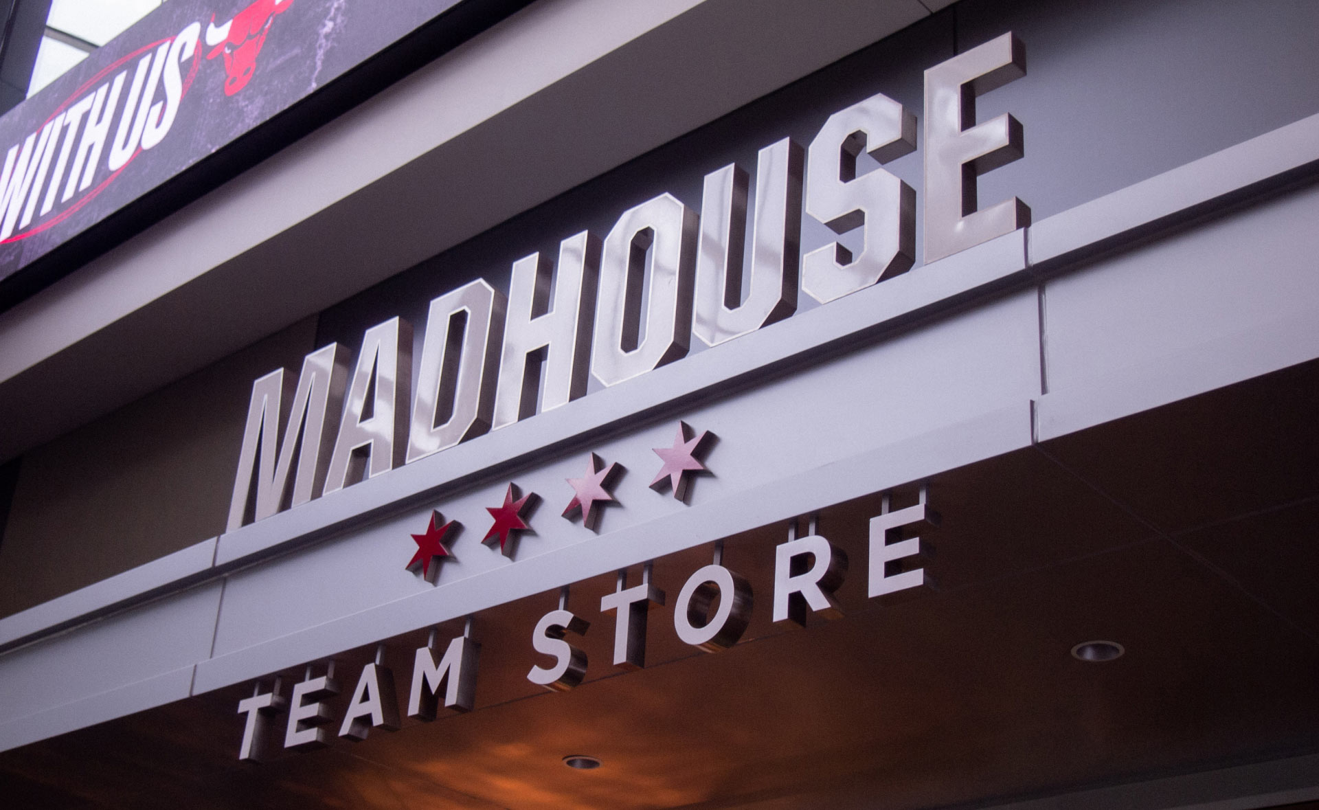A photo of the Madhouse Team Store indoor entrance signage