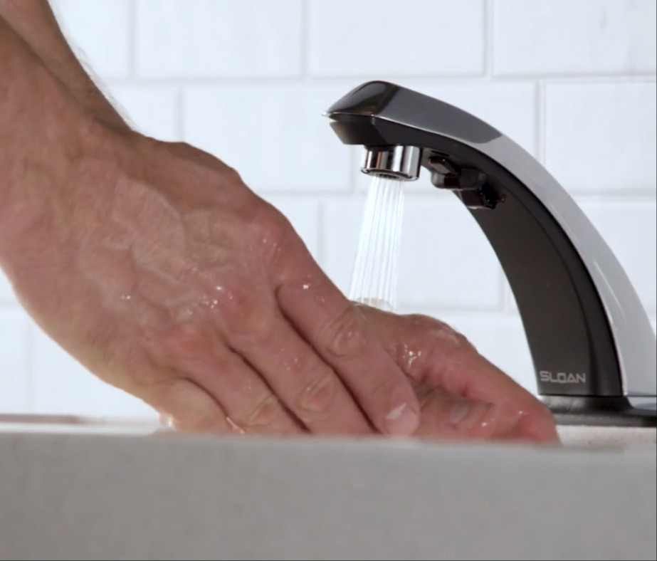 An image of a mans hands being washed under a Sloan smart faucet